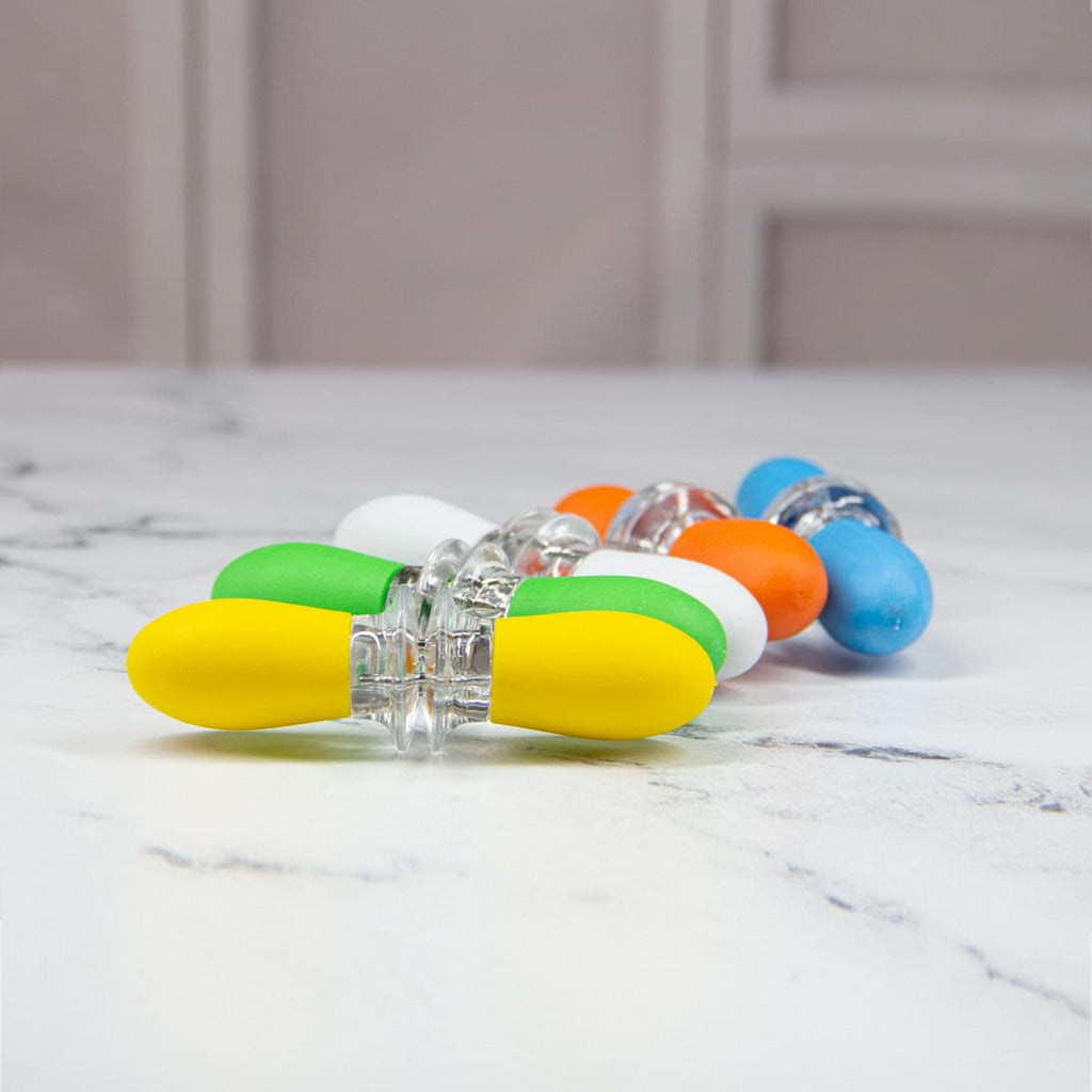 A group of Corn on the Cob Holders by Grand Fusion Housewares, LLC on a marble counter.