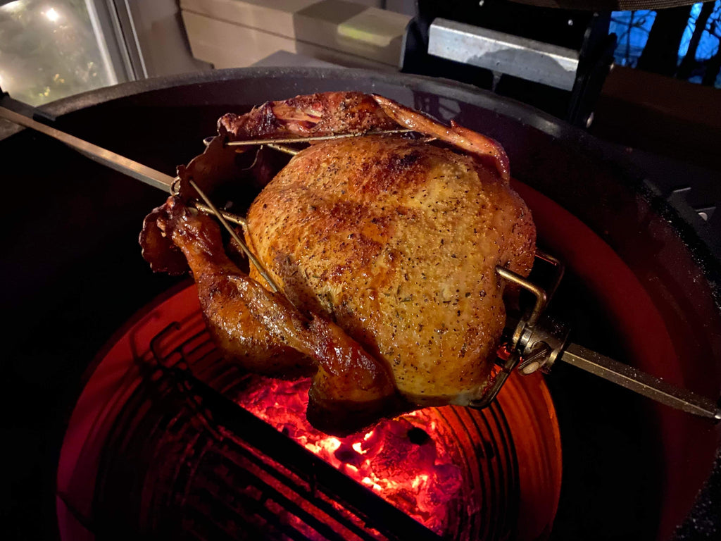 A Turbo Trusser for Chicken or Turkey, featured on Shark Tank from Grand Fusion Housewares, LLC and XSpecial, is sitting on a grill in front of a fire.