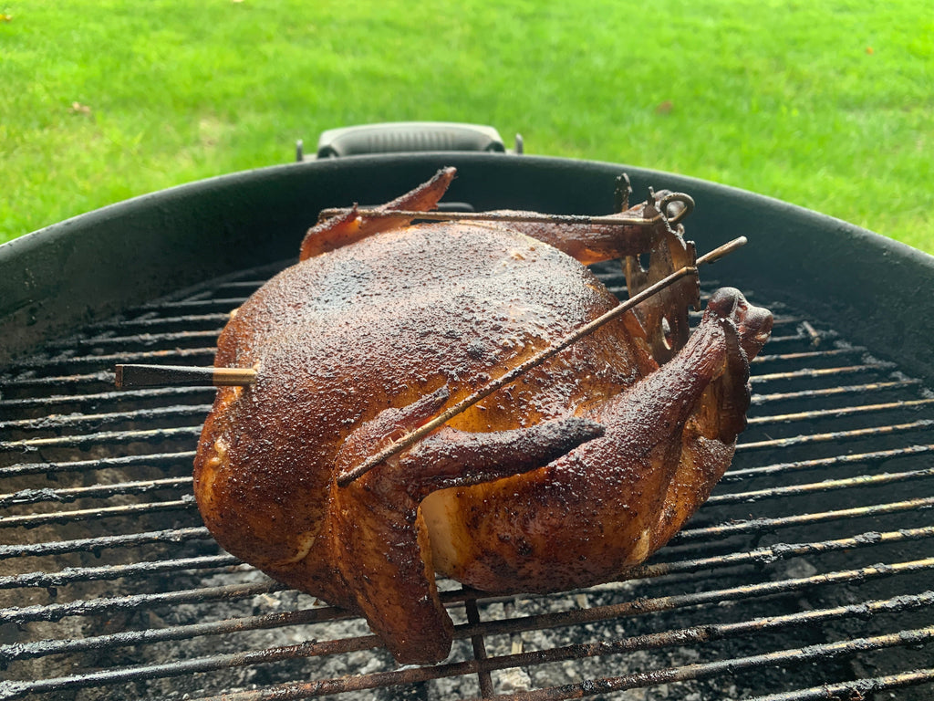 A Turbo Trusser for Chicken or Turkey by Grand Fusion Housewares, LLC on a grill with skewers sticking out of it for the XSpecial Marketplace.