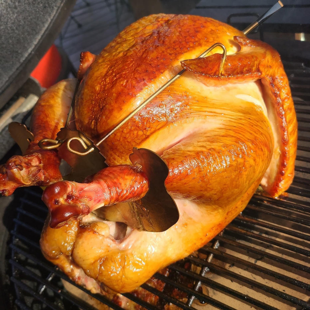 A Turbo Trusser for Chicken or Turkey, featured on Shark Tank, is sitting on a grill in the XSpecial Marketplace.