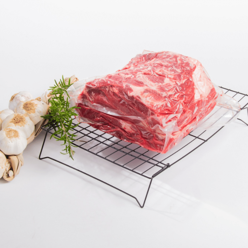 A specially wrapped piece of meat on a rack, perfect for meat lovers and using the Blade Meat Tenderizer Tool.