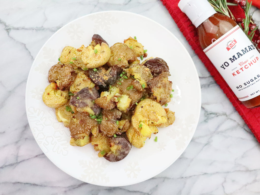 A plate with mashed potatoes and a bottle of Keto Condiment Gift Set by Yo Mama's Foods, perfect for Foodies.