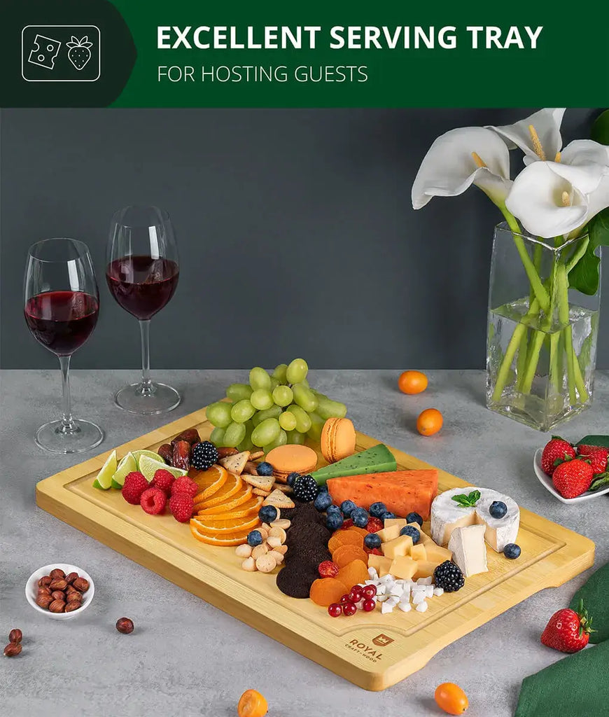 A XSpecial Blade Meat Tenderizer Tool enhances the Bamboo cutting board 12x18 by Royal Craft Wood with fruit and wine on it.