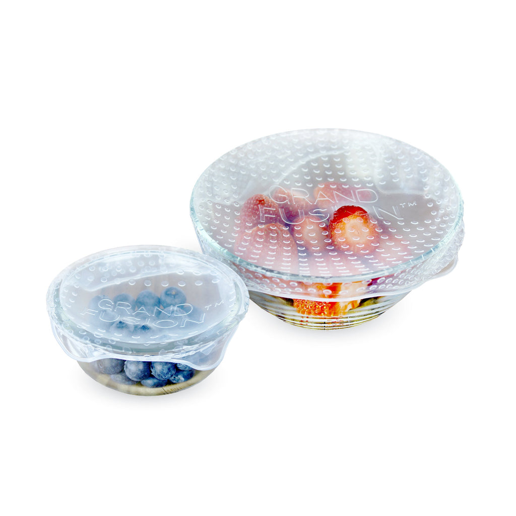 Two bowls with Grand Fusion Housewares, LLC Silicone Food Wrap 4 Pack, Flexible covers for glass, ceramic bowls on a white surface.