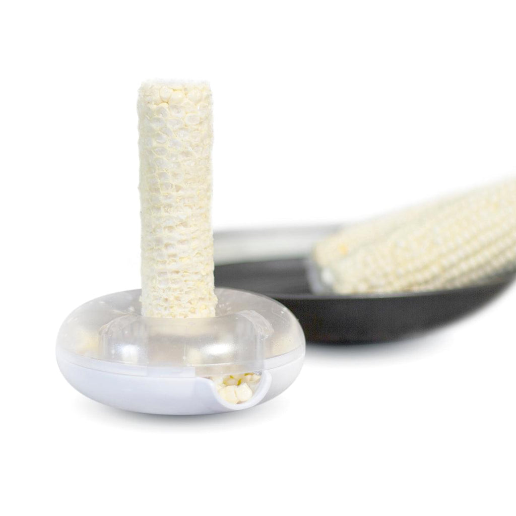 A Grand Fusion Housewares, LLC Corn Peeler is sitting on top of a pan in the XSpecial Marketplace.