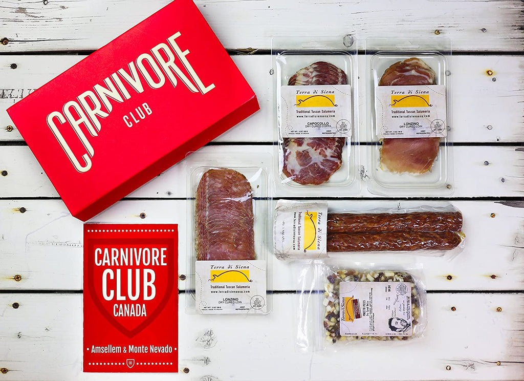A Carnivore Club Classic Box Sampler for Foodies and Meat Lovers on a wooden table.