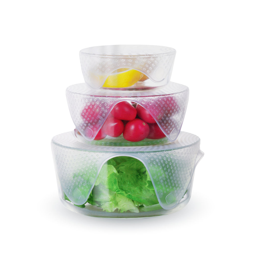 A stack of XSpecial Silicone Food Wrap 4 Pack, Flexible covers for glass, ceramic, and metal containers with vegetables in them.