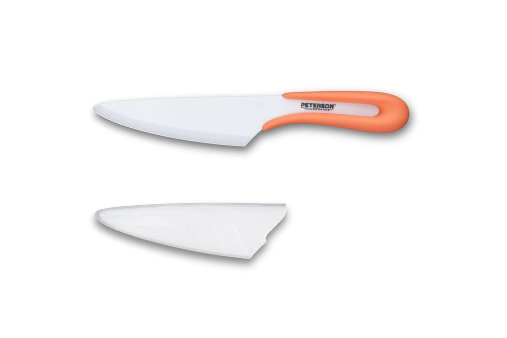 A Ceramic knife - 5" U HANDLE CERAMIC KNIFE for Meat Lovers by Peterson Housewares & Artwares in white and orange on a white surface.