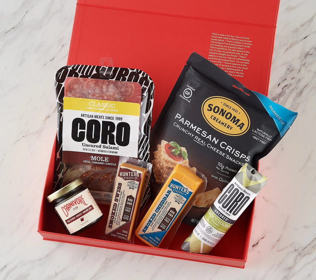 A red box with Carnivore Club Complete Box Sampler by Carnivore Club USA, Meat Lovers.