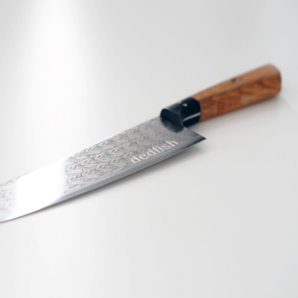 A 50% OFF with Purchase - Dedfish Co. Kitchen Knife Set by Carnivore Club USA with a blade meat tenderizer tool, ideal for foodies, on a white surface.