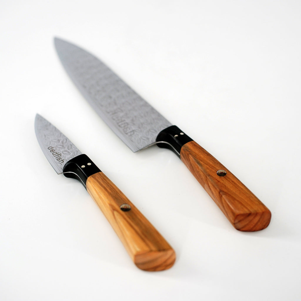 Two XSpecial Dedfish Co. Kitchen Knives with wooden handles perfect for Foodies on a white surface.