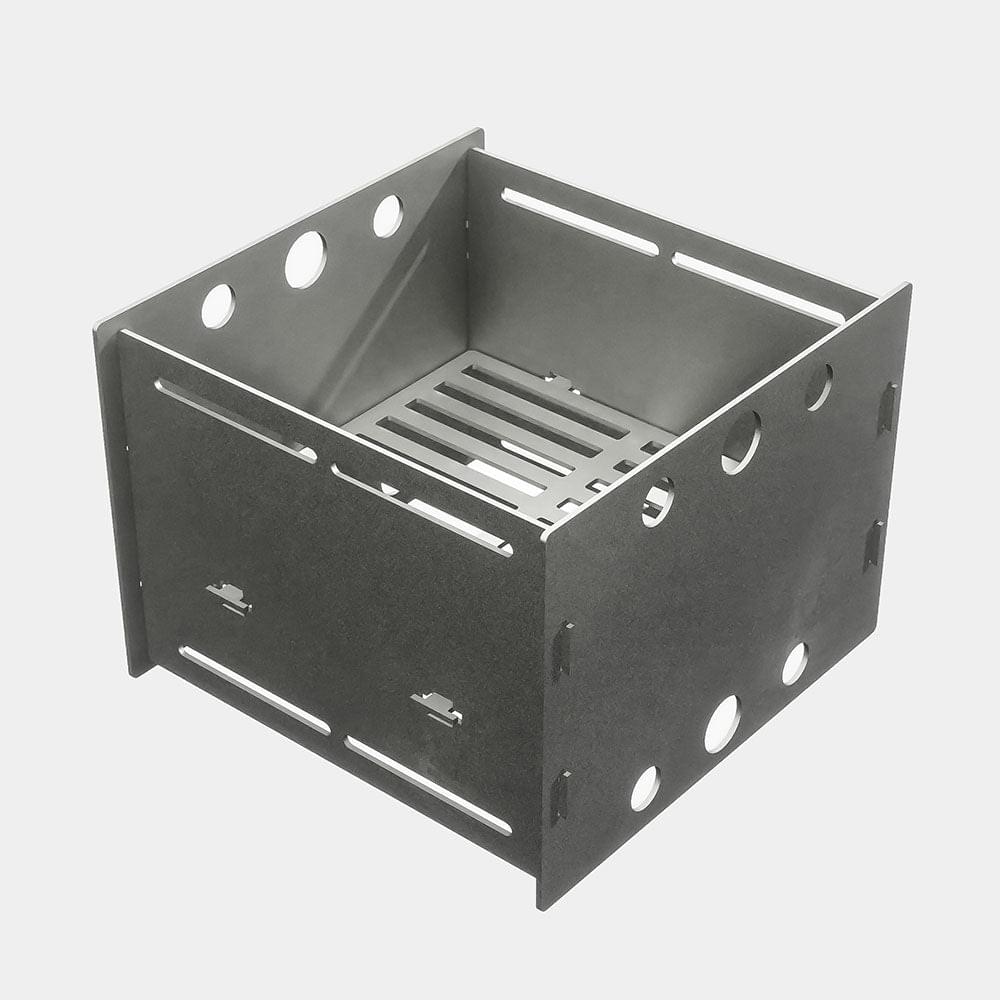 A square metal box with holes in it, the Fuel Saver For All 30" and 40" Grills by Arteflame Outdoor Grills, incorporating XSpecial's Blade Meat Tenderizer