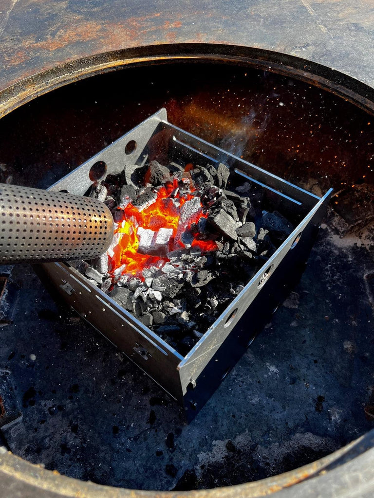 A fire is burning in an Arteflame Outdoor Grills fire pit equipped with a Fuel Saver For All 30" and 40" Grills.