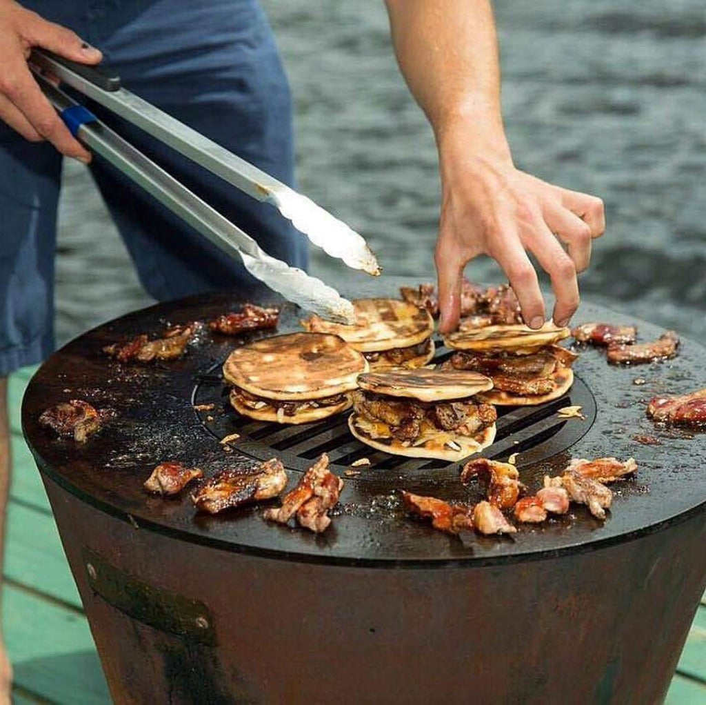 A man is preparing pancakes on an XSpecial Blade Meat Tenderizer Tool.