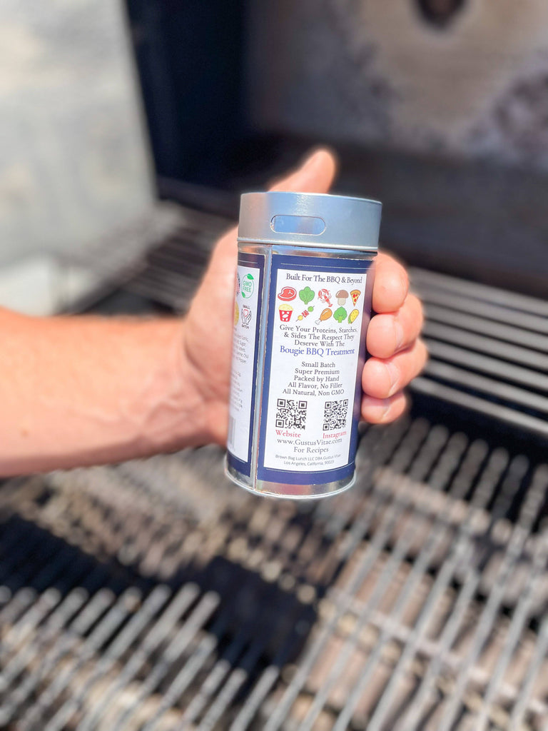 A person grilling with Brazilian Steakhouse BBQ Blend by Gustus Vitae, a gourmet spice blend.