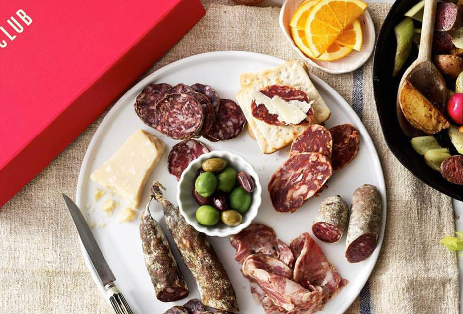A Classic Box by Carnivore Club USA, perfect for Meat Lovers, featuring a variety of meats and cheeses with the addition of a Meat Tenderizer Tool.