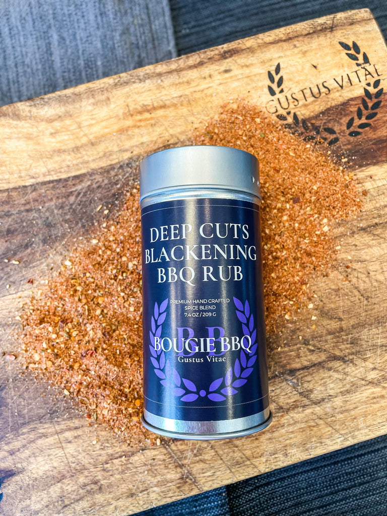 A tin of Deep Cuts Blackening BBQ Rub & Seasoning by Gustus Vitae on a cutting board, perfect for grilling enthusiasts and seasoning lovers.