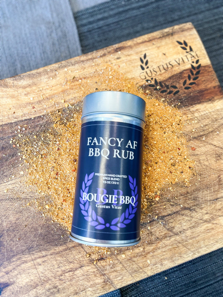 A can of Fancy AF BBQ Rub by Gustus Vitae on a cutting board.