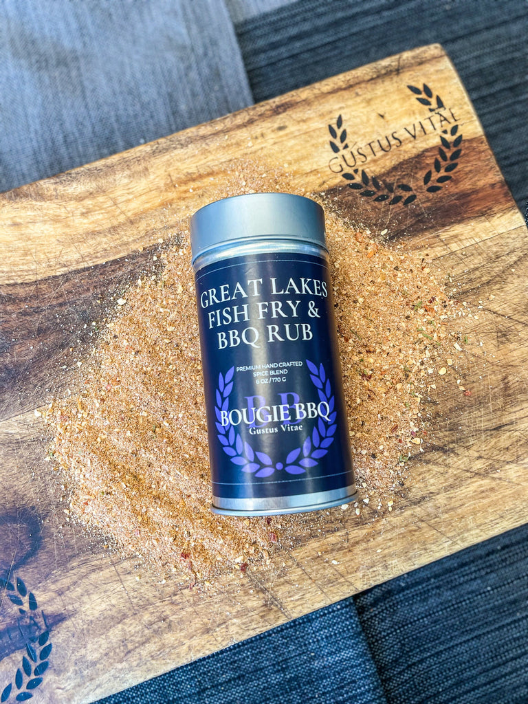 A tin of Great Lakes Fish Fry & BBQ Rub by Gustus Vitae on a cutting board.