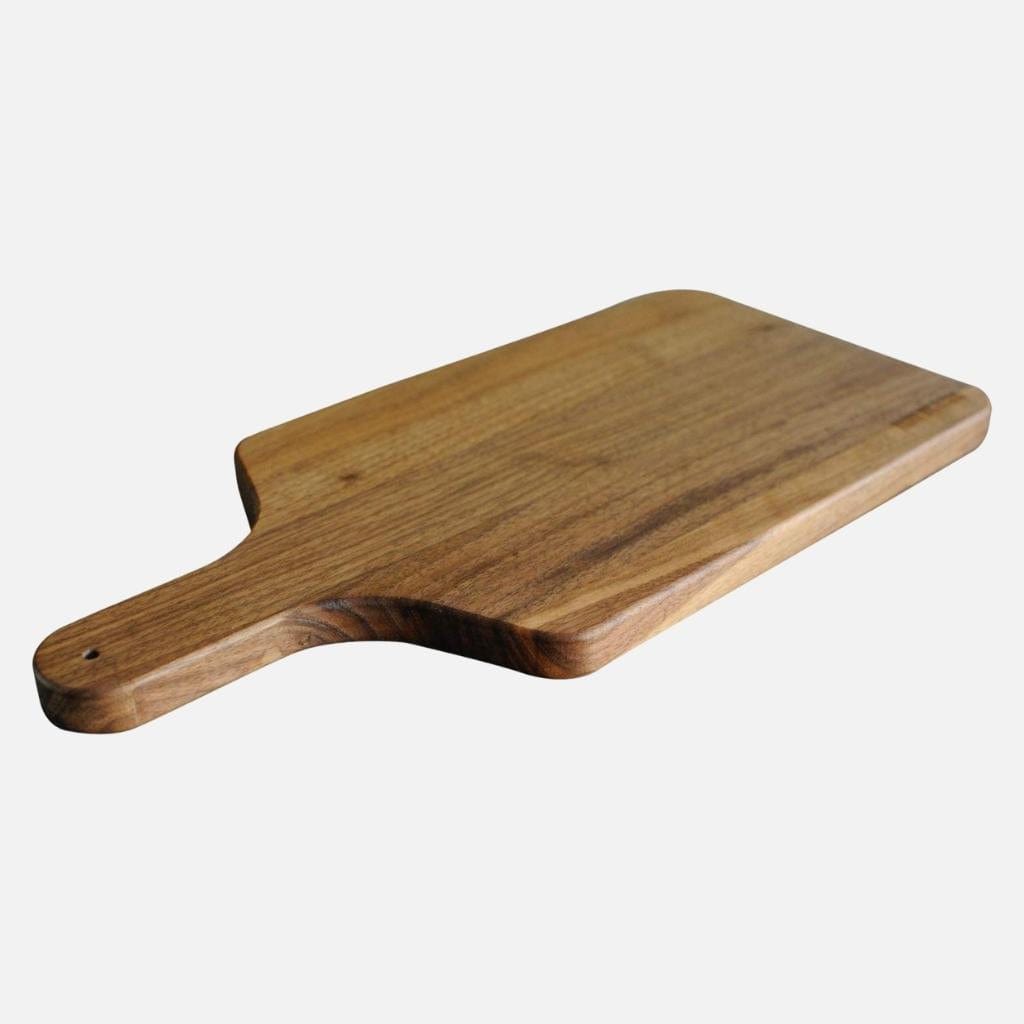 A Walnut Charcuterie Paddle by Virginia Boys Kitchens on a white background showcasing exceptional craftsmanship.