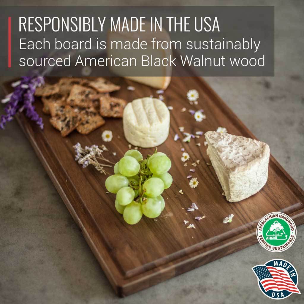A Medium Walnut Wood Cutting Board by Virginia Boys Kitchens adorned with cheese, grapes, and walnuts, perfect for foodies.