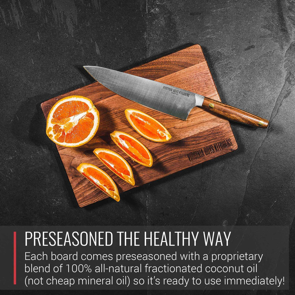 A Small Walnut Wood Cutting Board from Virginia Boys Kitchens with oranges and a knife, perfect for Meat Lovers.
