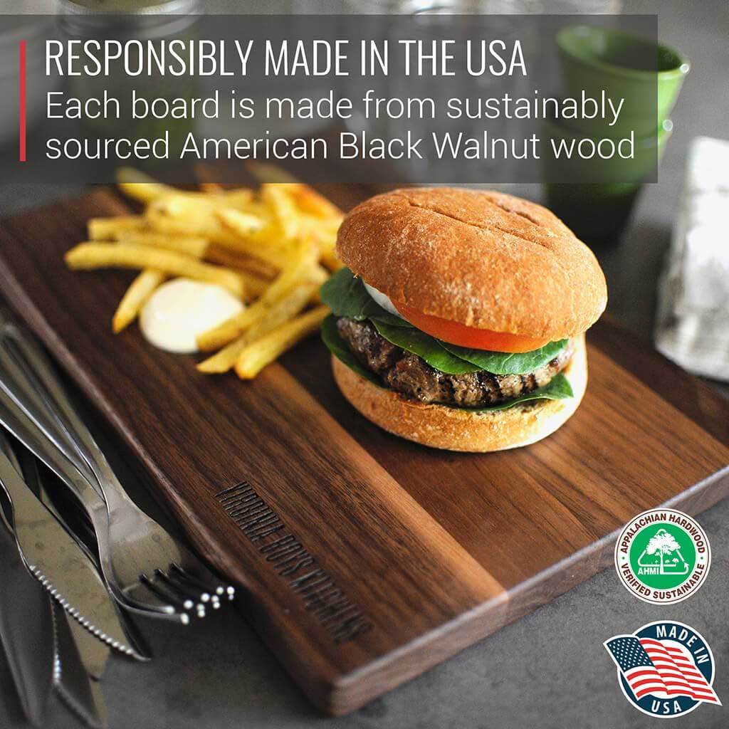 A gourmet cutting board made of small walnut wood, complemented by a juicy burger and crispy fries from Virginia Boys Kitchens, perfect for meat lovers and foodies.