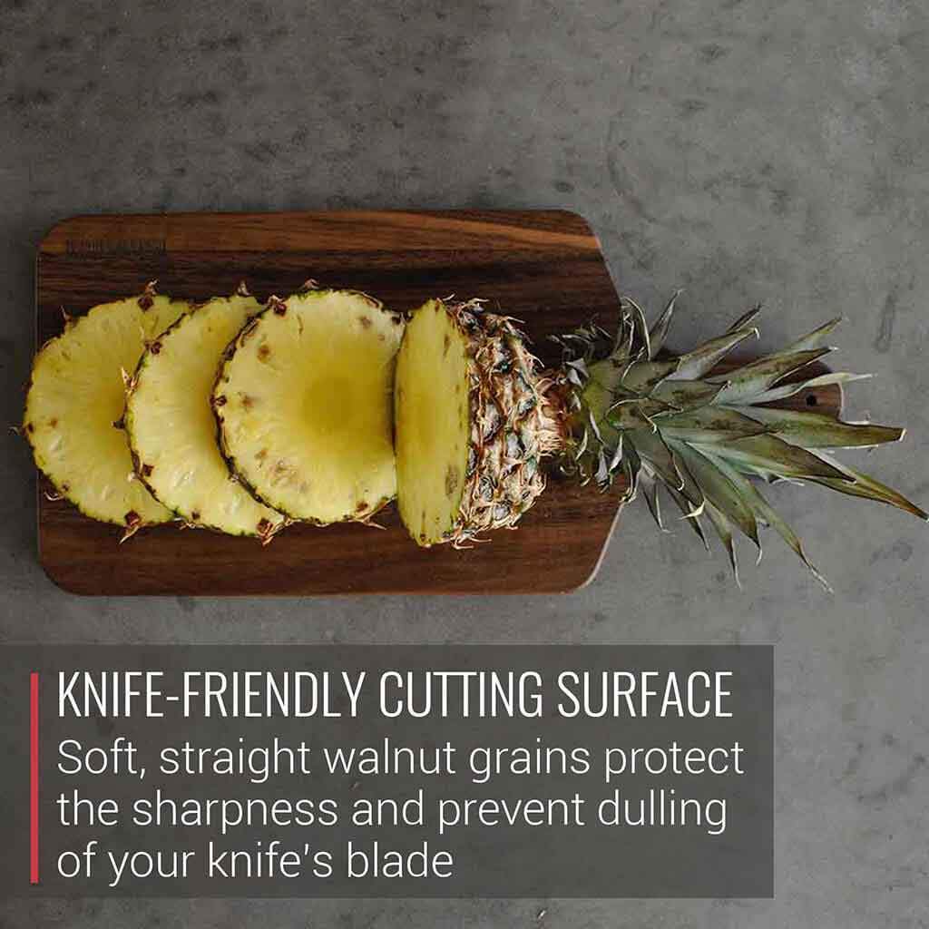 A Meat Lovers' Walnut Cutting Board and Charcuterie Paddle with Handle by Virginia Boys Kitchens, featuring a knife-friendly cutting surface for foodies.